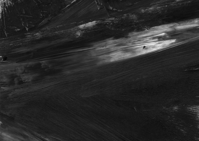 abstract painting representing busy road intersections as part of an urban city scape, what appears to be a tower block looms in the distance