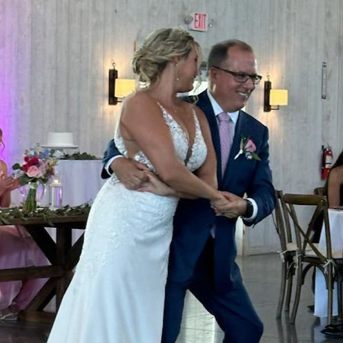 Bride and father partner dancing at a wedding reception