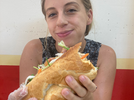 Author of the blog holding a half eaten banh mi