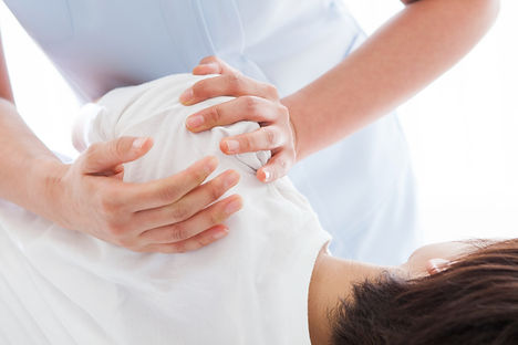 A chiropractor doing a shoulder treatment.