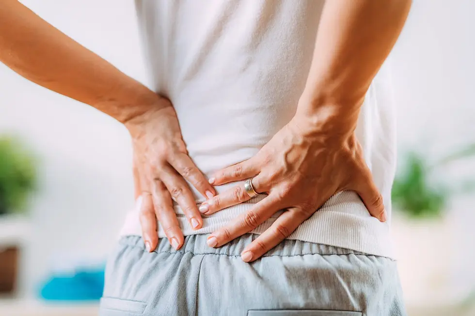 Person with back pain. Learn how to biohack back pain with expert advice from a Georgetown Chiropractor.