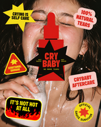 Flash-lit close-up of a woman crying while drinking milk from a glass bottle, surrounded by playful Crybaby Hot Sauce-inspired stickers reading “Crying Is Self Care,” “100% Natural Tears,” “Emotional Damage,” “It’s Not Hot at All,” and “Crybaby Aftercare.”