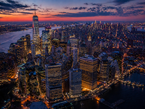 An aerial view of a financial district at dusk.