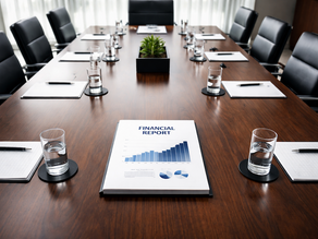 A high-angle shot of a clean, modern executive boardroom table with a single, neatly bound financial report at the center — projecting strategic clarity and boardroom authority.