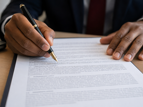 A close-up photograph of an executive's hands reviewing a complex financial contract with a fountain pen, focusing on the fine print rather than the front cover page.