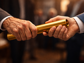 Two hands passing a baton — one experienced, one younger — representing the deliberate, timed transfer of authority in a family business transition.