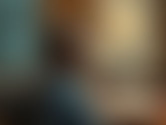 A serene image of a leader sitting quietly in a boardroom before a meeting begins.