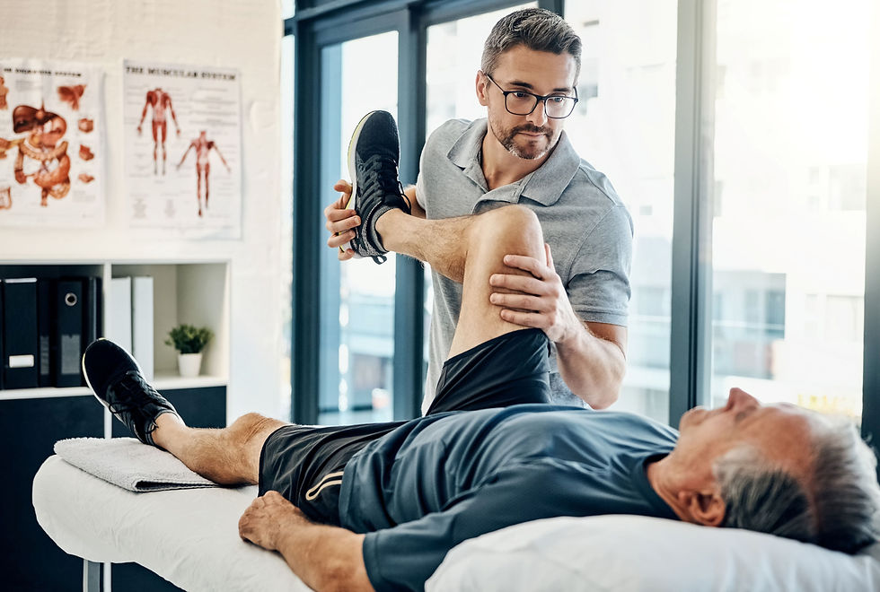 Physical Therapist Stretching Patient's Leg in Office.