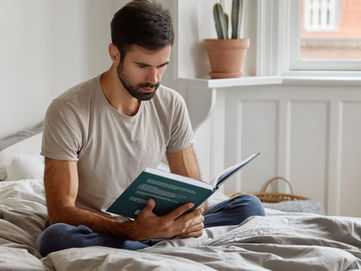 A fit, relaxed man reading a health journal