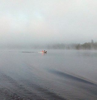 Geophysical marine survey crew driving a boat on a lake