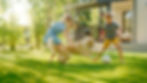 Two Kids Have fun with Their Handsome Golden Retriever Dog on the Backyard Lawn. They Pet,