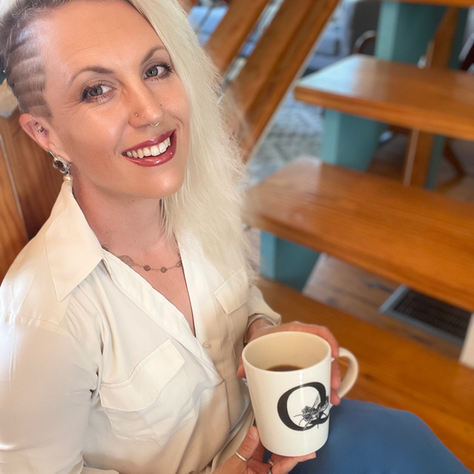 Woman sitting on a staircase with a cup of coffee
