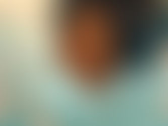 A serene woman with closed eyes is surrounded by pink flowers on a teal and beige background, conveying tranquility and beauty.