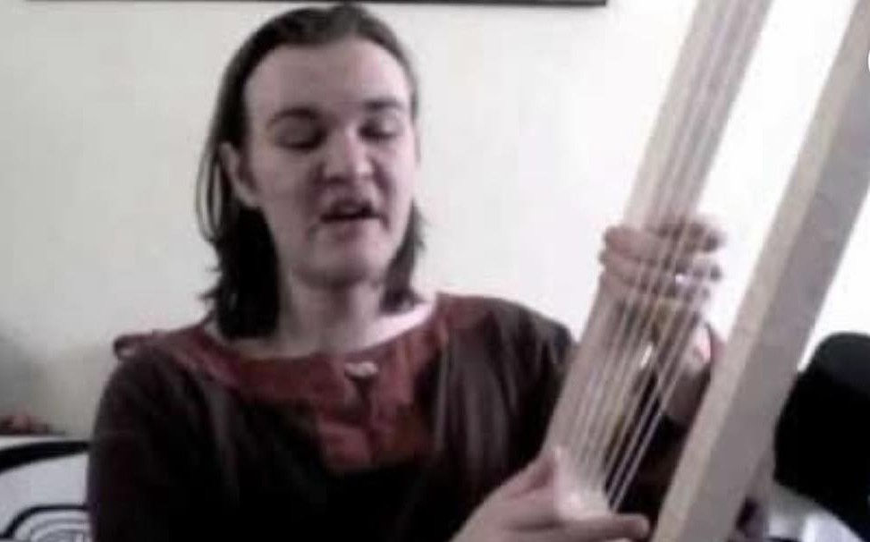 man playing a lyre