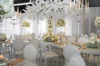 Elegant wedding reception with white floral arrangements
