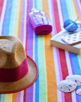 vacation items on beach blanket