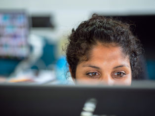 A girl engineer working at a computer, showing what an engineer actually does day to day