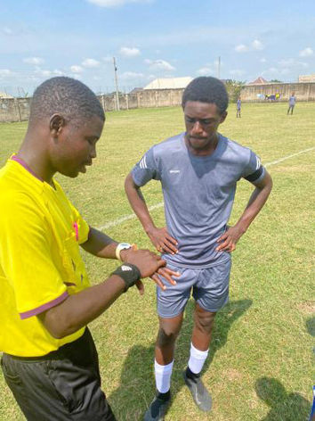 Victor Angaye talking with a soccer ref