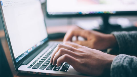 Software developer writing tests on a laptop.