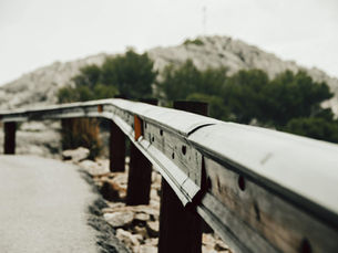 Close-up of a metal guardrail on a mountain road in Mallorca, Spain.