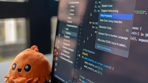 Developer working with an AI coding assistant on a laptop