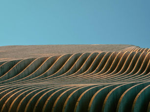 Curved patterns in modern architectural design against a clear blue sky in Athens, Greece.