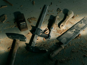 Vintage woodworking tools on a dusty workshop floor, evoking craftsmanship.
