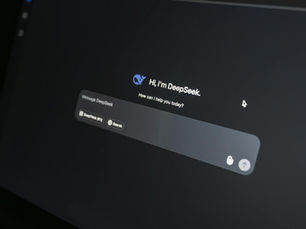 Close-up of DeepSeek AI chat interface on a laptop screen in low light.