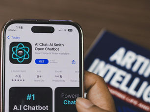 Hand holding a smartphone with AI chatbot app, emphasizing artificial intelligence and technology.