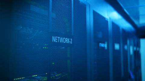 A modern server room featuring network equipment with blue illumination.