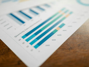 Close-up of a quarterly sales report showing bar charts on paper.