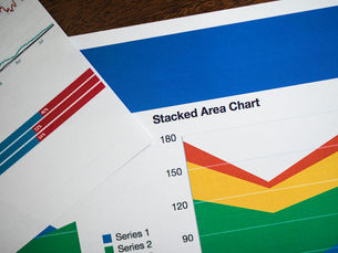 Vivid stacked area chart and graphs on paper, showcasing data analysis.