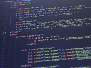 Close-up view of HTML and CSS code displayed on a computer screen, ideal for programming and technology themes.