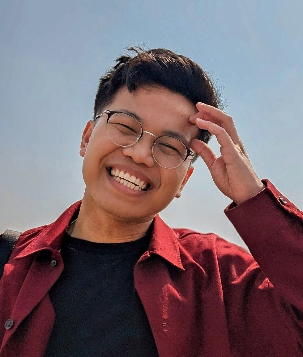 Portrait of Chris Lansang, the primary SLP of Extra Heart. He is smiling and wearing glasses.