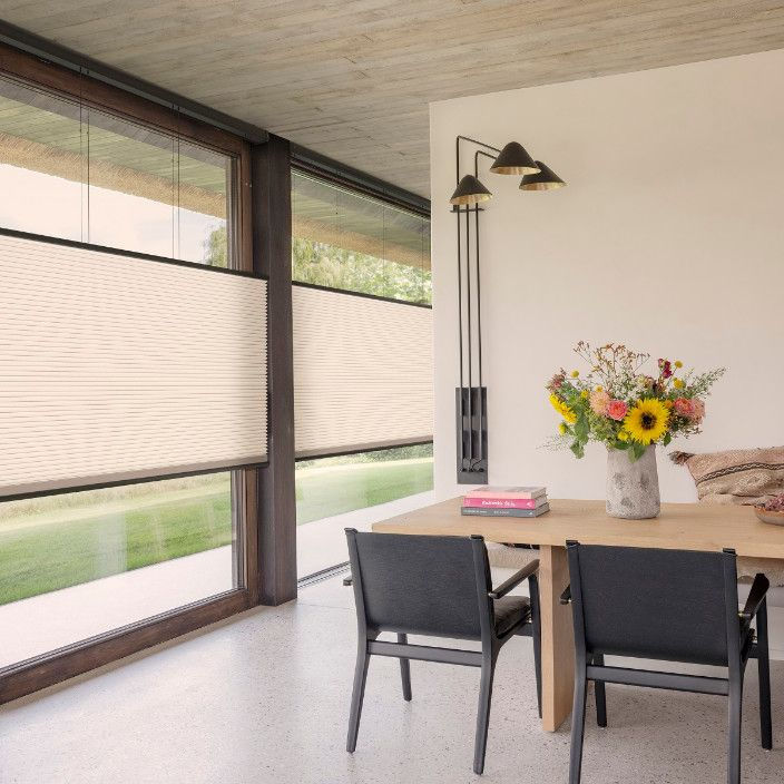 Wide angle view of honeycomb blinds in various colors and styles
