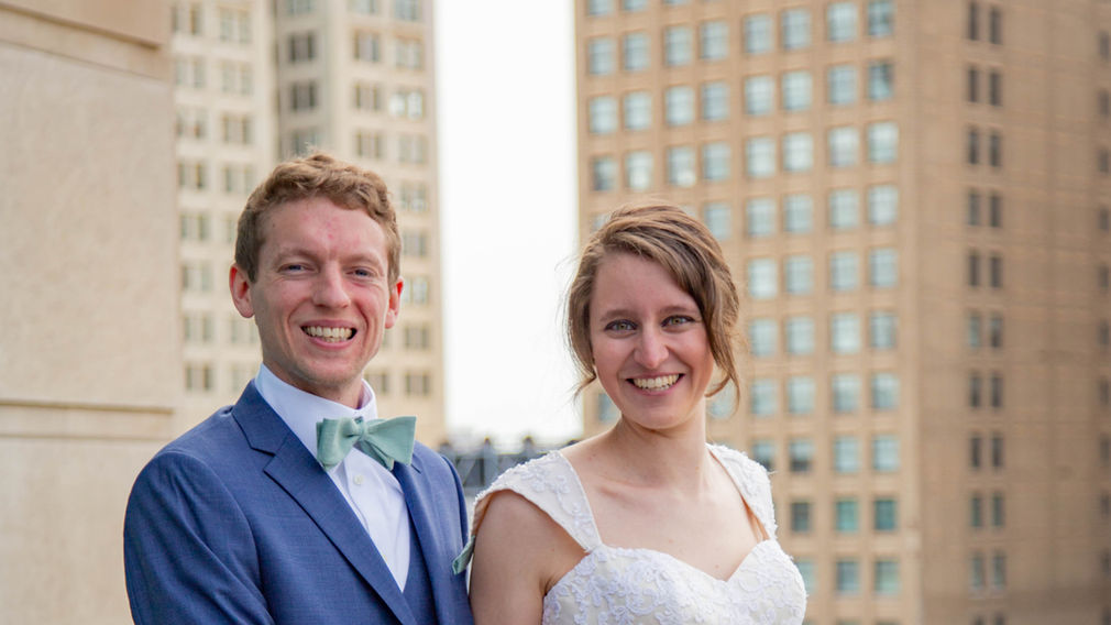 Meghan and Brandan with Detroit City building behind them