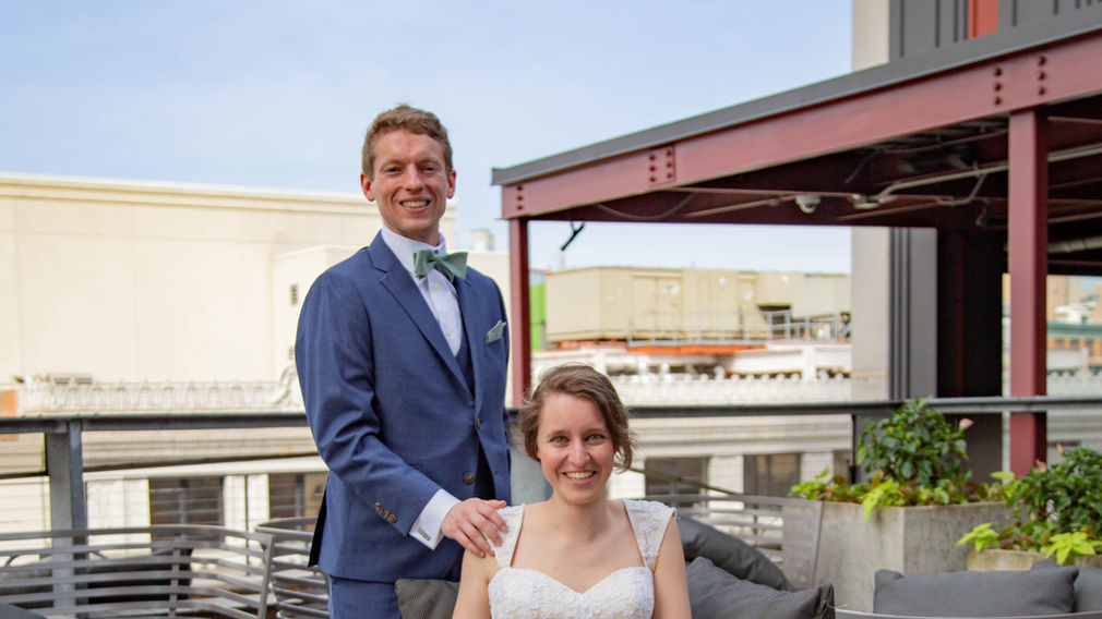 Meghan and Brandan pose on the rooftop of the Madison