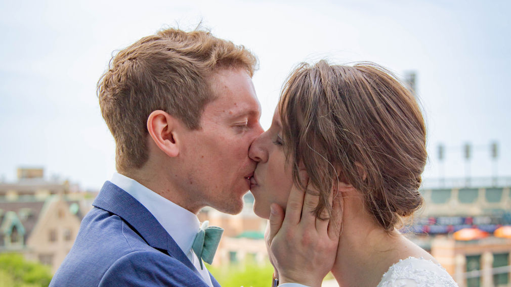 Bride and Groom kiss with Detroit behind them