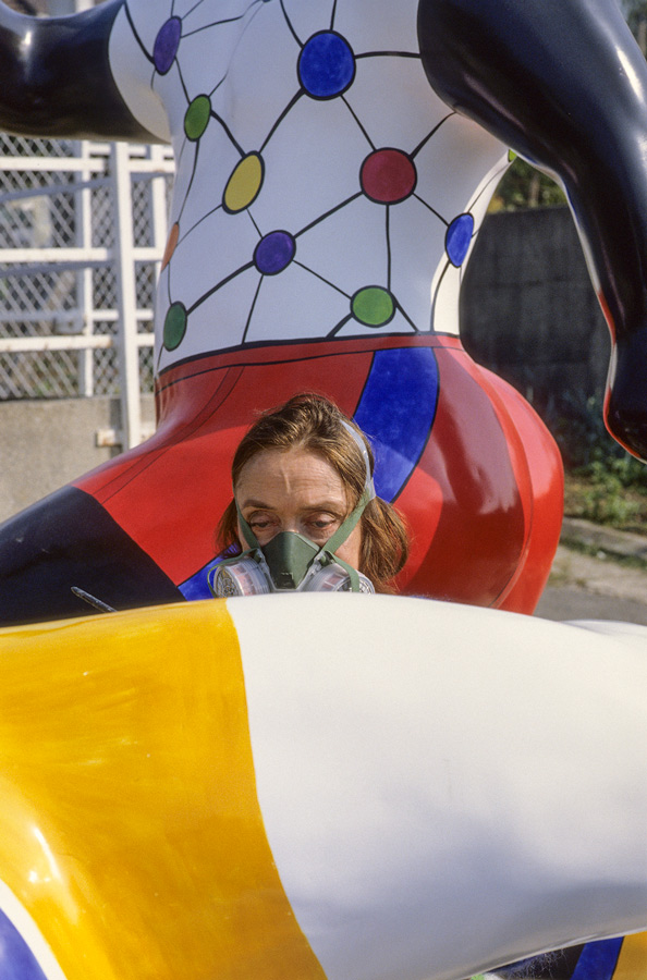Niki painting, with a mask on