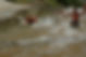 2 people sliding down a creek