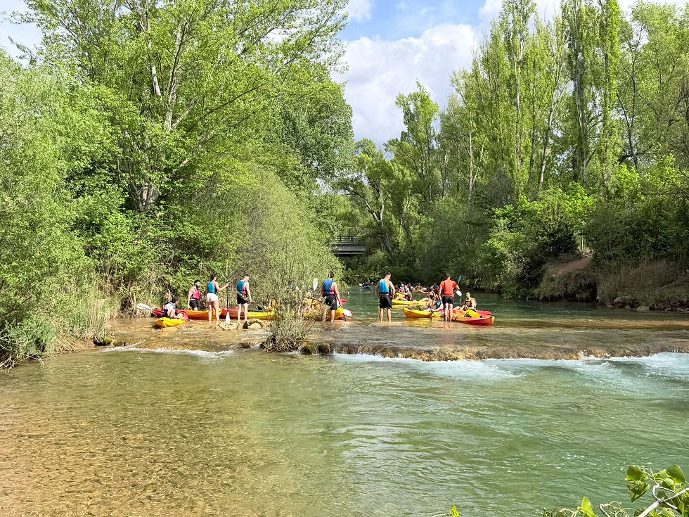 Vista aérea de un grupo navegando en piragua por un río en Villalba de la Sierra