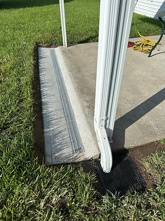 Channel drain install near patio in combination with downspout and catch basin install