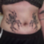 Jade Wildman tattoo bold blackwork traditional symmetrical spiders on stomach female