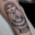 Jade Wildman tattoo bold blackwork tattoo of Russian doll with ornamental detailing forearm female