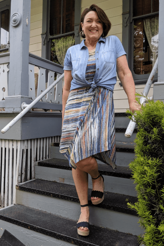 Cover your arms with a button up chambray shirt over a knit sleeveless dress.