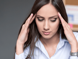 A woman who made mistakes in marketing cradles her head in her hands in frustration