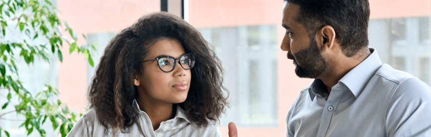 A man and woman showcasing the benefits of mentoring during a session