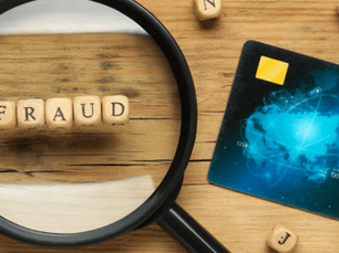A magnifying glass and a credit card signifying fraud prevention