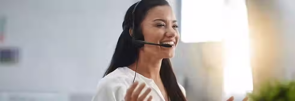 A woman speaking with a customer on the phone, providing a great user experience