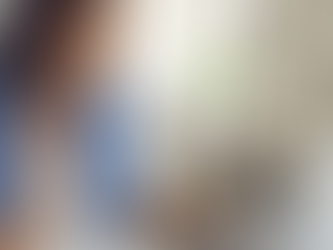 Woman staring intently at a laptop computer while taking notes